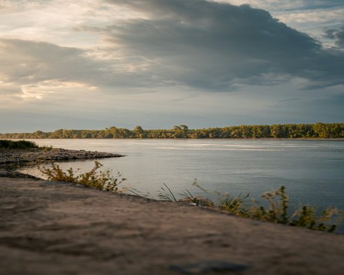 calm nature view along the Danube river with warm sunset lighting